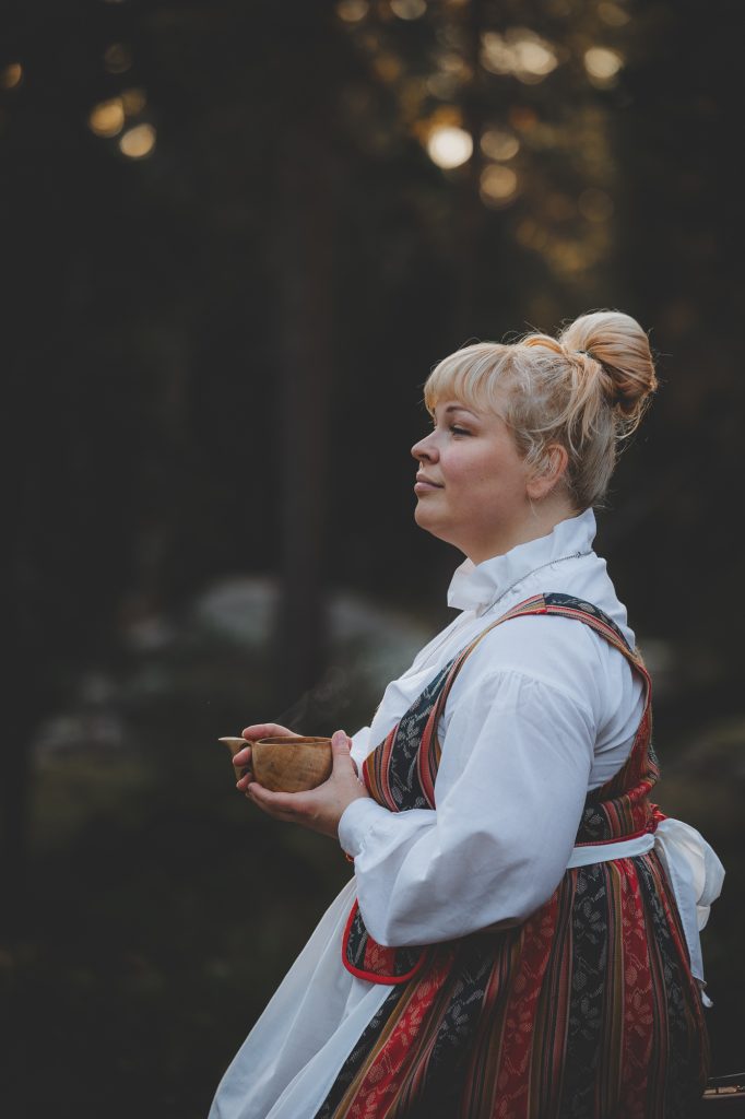 Performer enjoying a quiet moment with a cup of coffee — meaningful experiences in Finland don't always require you to pick up the pace.